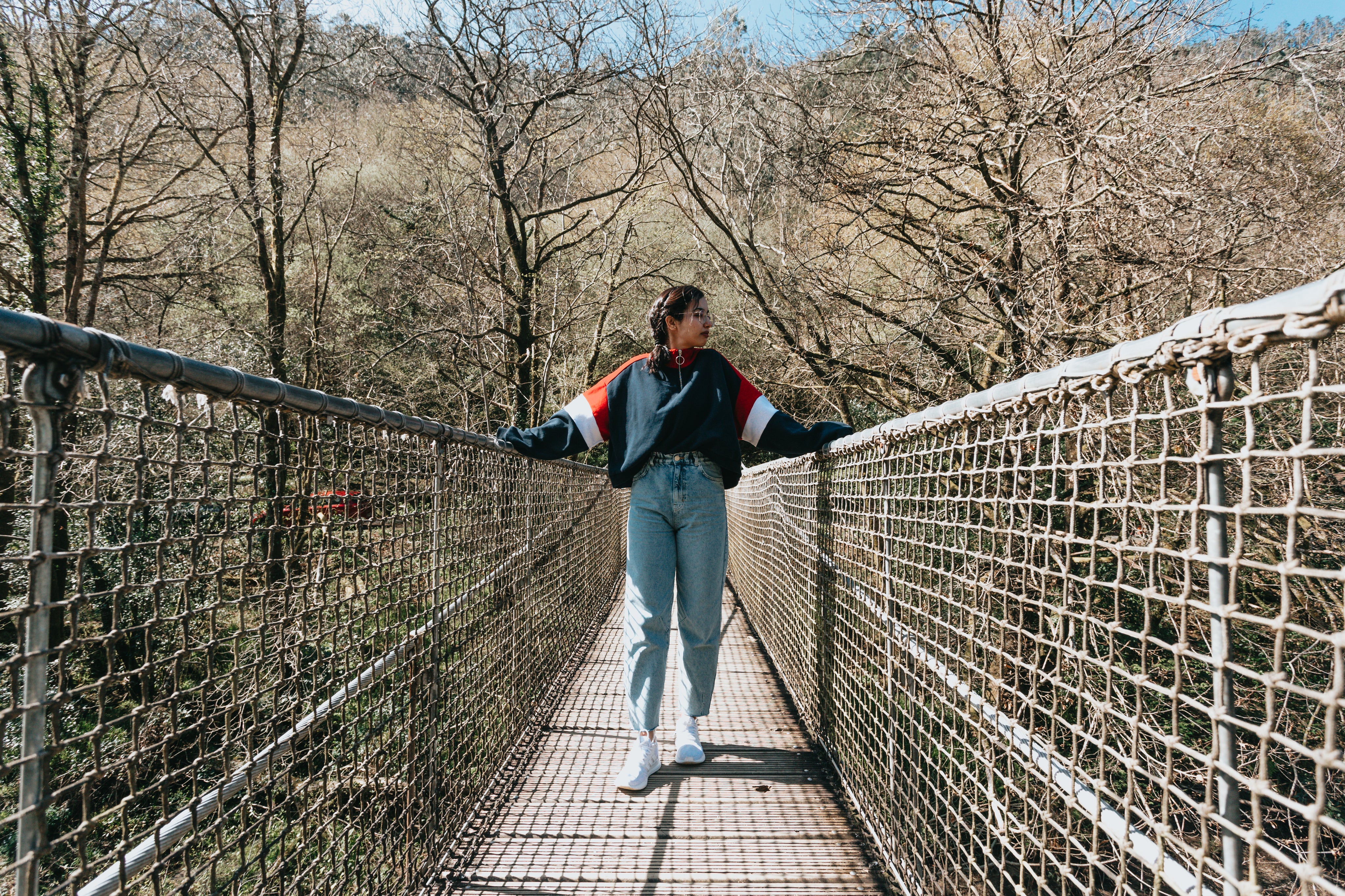 files/person-stands-on-a-bridge-with-one-hand-on-each-railing.jpg